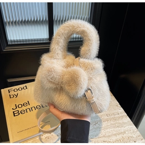 Close-up of plush bucket bag with soft faux fur texture and adjustable PU strap