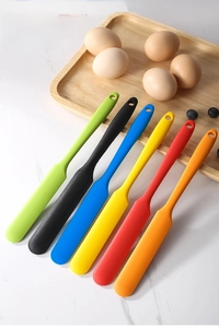 Detailed set of six colorful silicone spatulas on a wooden tray for cake baking