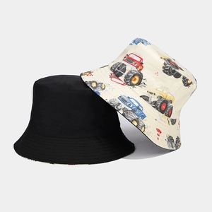 Detail of reversible cotton bucket hats in solid black and colorful cartoon patterns