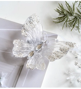Macro view of transparent acrylic butterfly ornament with silver glitter and rhinestones