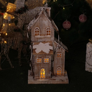 Lighted wooden Christmas house decoration with faux snow roof and warm LED glow
