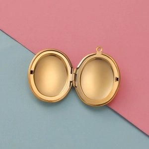 Macro detail of the interior of an open oval-shaped golden locket pendant necklace