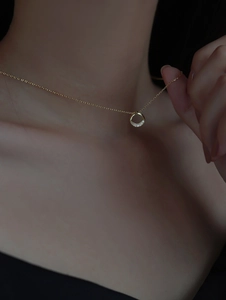 Close-up of S925 sterling silver necklace with a gold plated minimalist zircon ring pendant