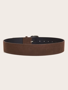 Detailed view of wide dark brown suede waist belt featuring a simple silver metal buckle