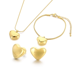 Polished gold heart jewelry set featuring minimalist necklace, bracelet, and stud earrings