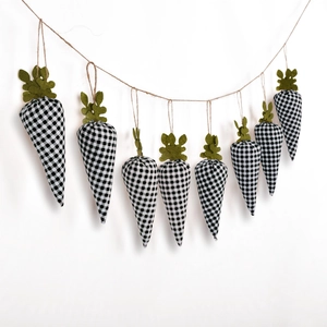 Hanging Easter carrot banner featuring black and white plaid fabric on a rustic twine string