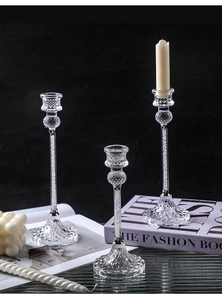 Detailed view of three tiered glass candle holders with crystal fill and textured bases