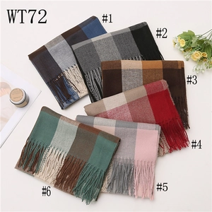 Macro shot of six checkered tassel scarves in various colors with soft fabric texture