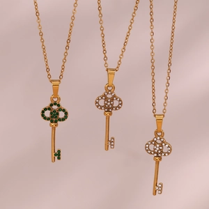 Three gold stainless steel key necklaces with green emerald, pearl white, and diamond inlays