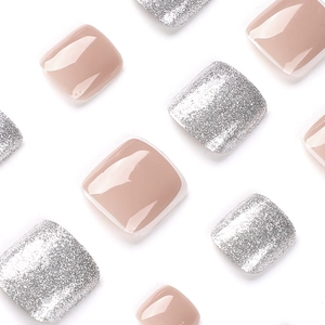 Glossy nude and silver glitter press-on toenails for a professional French pedicure look