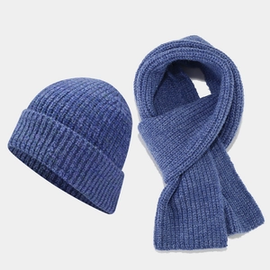 Detail of navy blue thick ribbed knit texture on winter hat and scarf set for outdoors