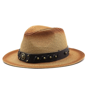 Detail of gradient straw panama hat featuring vintage leather band and metal rivets