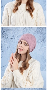 Detail of pink knit hat with textured weave and small decorative beads for winter