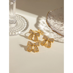 Close-up of 18k gold plated stainless steel bow jewelry set with sparkling crystals