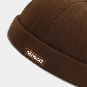 Detail of the high-density cotton brim with embroidered 'all about' patch on retro miki hat