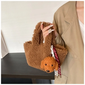 Detailed close-up of brown faux shearling tote bag with a matching plush dog charm