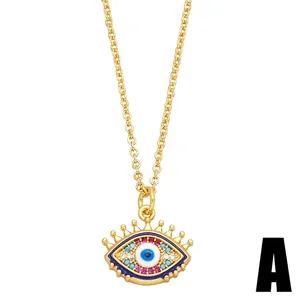 Golden Evil Eye necklace pendant with colorful crystals and blue enamel accents