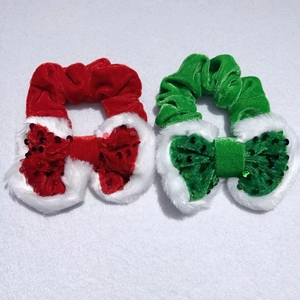 Detail of velvet hair scrunchies with white faux fur trim and shiny sequins for Christmas