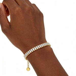 Elegant gold-plated tennis bracelet featuring rectangular cubic zirconia on a female wrist