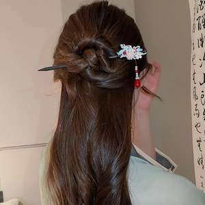 Detail of floral butterfly hair stick with tassels worn by model in traditional style