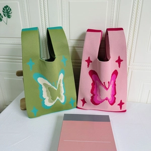 Knit tote bags with butterfly patterns in green and pink, featuring star star motifs