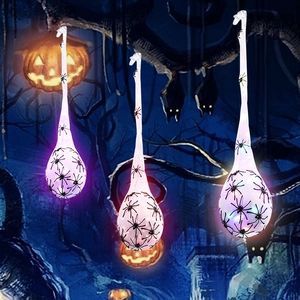 Halloween hanging spider egg sacks with glowing LED lights for spooky outdoor party decor