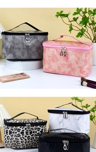 Detail of five makeup bags in crocodile, leopard, and marble patterns with top handles