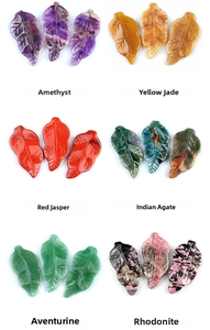 Macro shot of leaf-shaped natural crystals including amethyst and agate stone pendants