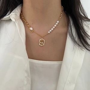 Baroque pearl necklace with gold rose pendant and vintage tulip design on a model