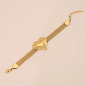Close-up of golden mesh chain necklace featuring a textured heart charm and adjustable clasp