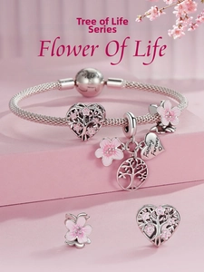 Macro detail of S925 sterling silver snake chain bracelet with pink flower charms