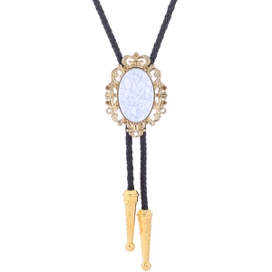 Detail of turquoise bolo tie featuring golden crown frame and black braided leather cord