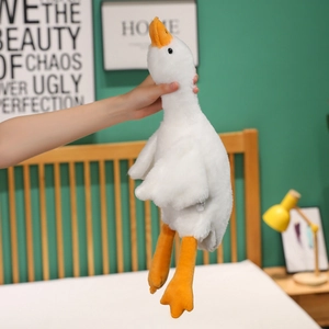 Detail showing plush white goose pillow made of soft material being held by the neck