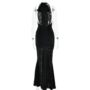 Back view of black halter neck maxi dress featuring ruched details and mermaid hemline