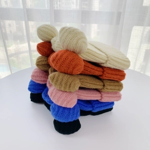 Detailed stack of ribbed knit beanies with cute bear ears in six vibrant autumn colors