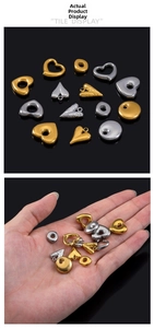 Close-up of heart and round stainless steel pendants for DIY jewelry making