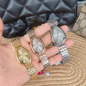 Detailed close-up of snake-head shaped women watches in gold, rose gold and silver steel