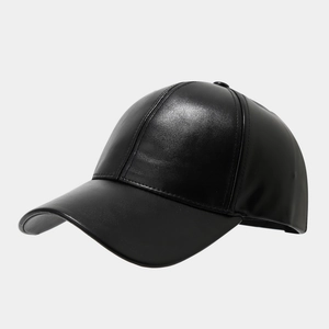 Detail of black faux leather baseball cap showing refined texture and curved brim