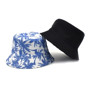 Detail of blue palm tree print and solid black fisherman hats in durable twill fabric