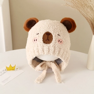 Detailed close-up of plush baby winter hat featuring cute embroidered bear ears and chin straps