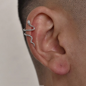 Detailed view of silver snake ear cuff with realistic scale texture on a model's ear