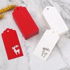 Macro view of red and white heart gift tags with Christmas reindeer cutout designs