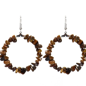 Close-up of bohemian hoop earrings with irregular brown natural stones and silver hooks