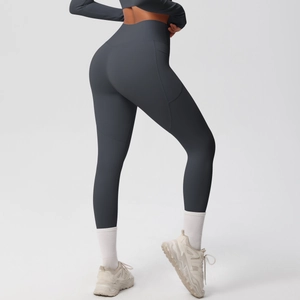 Detail of dark grey high waisted yoga pants featuring side pockets and a lifting design