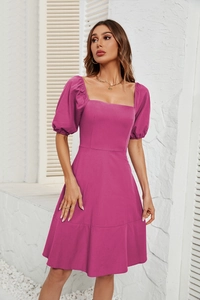 Detailed close-up of rose red puff sleeves and woven fabric texture on square neck dress