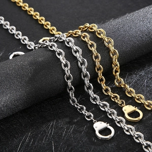 Golden and silver stainless steel handcuff link necklace displayed on a black stand