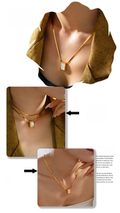 Model wearing a gold snake chain necklace with a vintage white shell rectangle pendant