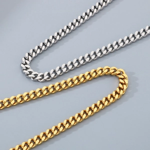 Detailed view of silver and gold Cuban link chains with polished metal surface