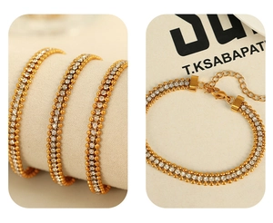 Detailed macro view of gold plated double-row rhinestone chain with adjustable lobster clasp