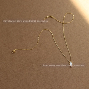 Detail of 18K gold plated cable chain with marquise white shell pendant and lobster clasp